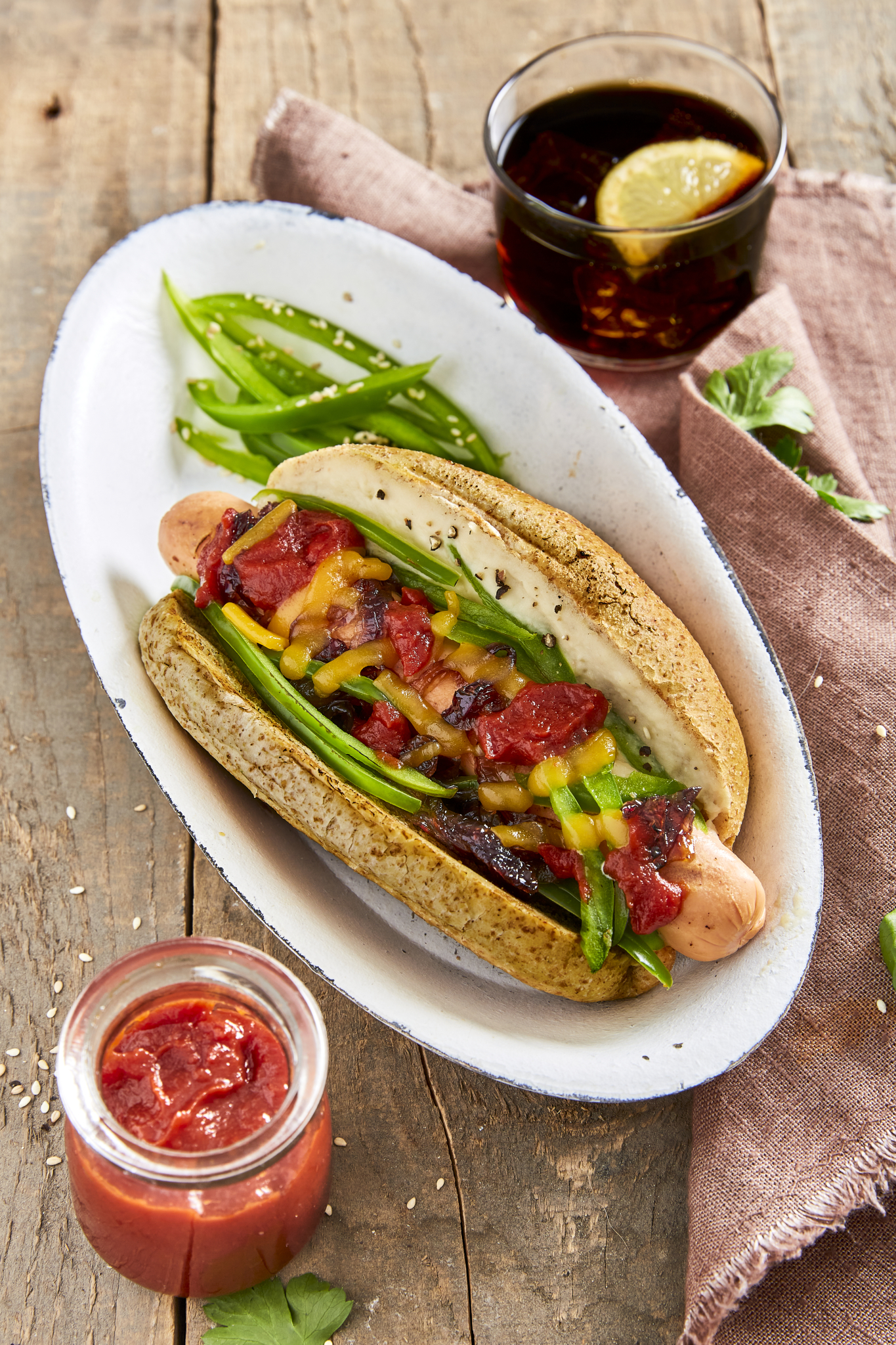 Gourmet hot dogs with cannellini sauce, sliced green pepper, caramelized red onions, shredded cheese