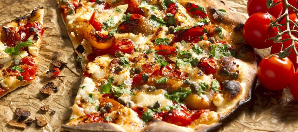 Pizza with tomatoes, goat cheese, bell peppers, capers and herbs Pizza with tomatoes, goat cheese, bell peppers, capers and herbs