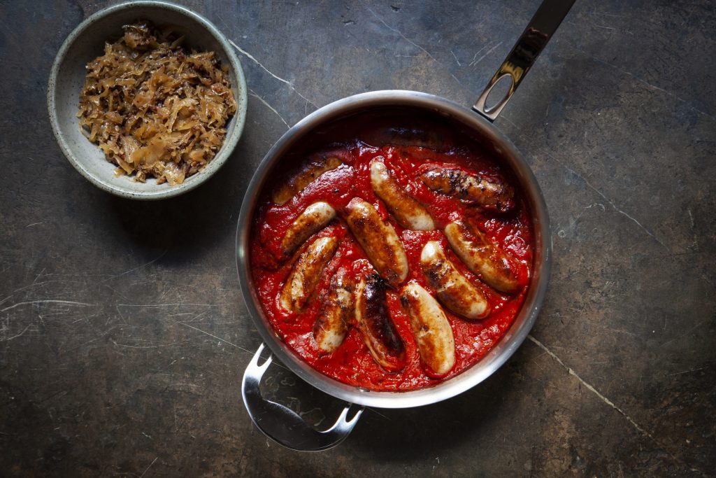 Lamb sausages in tomato sauce with bacon sauerkraut Lamb sausages in tomato sauce with bacon sauerkraut