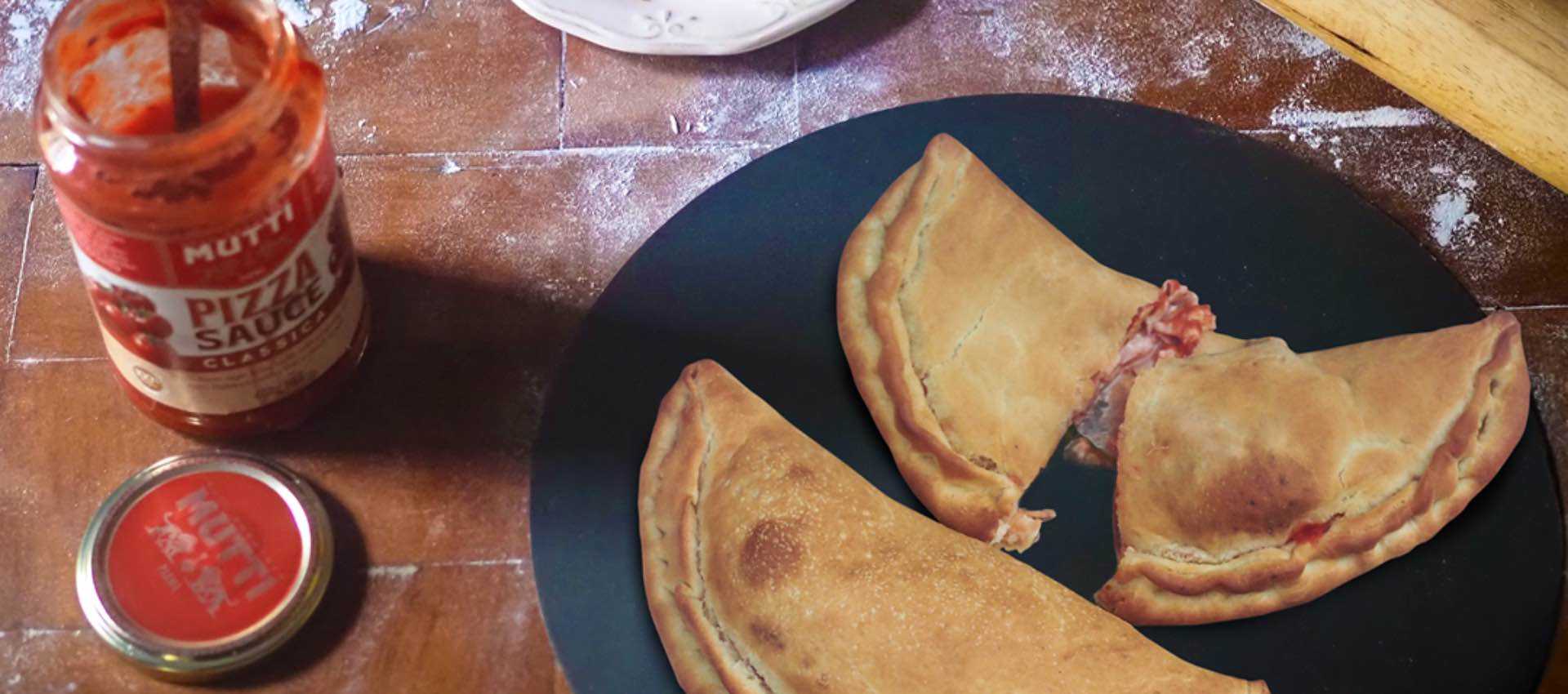 Smoked ham and mozzarella calzone with pizza sauce