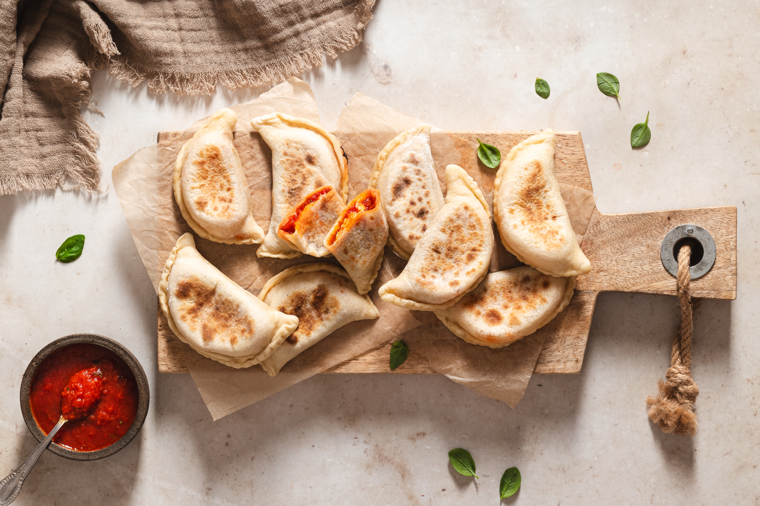 Italian homemade panzerotti with tomato and basil sauce