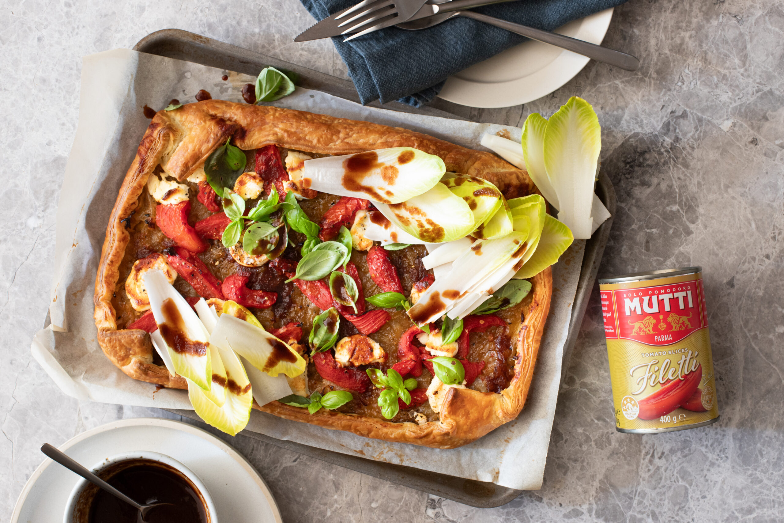 Mutti Tomato Filetti, caramelised onion and goat cheese tart