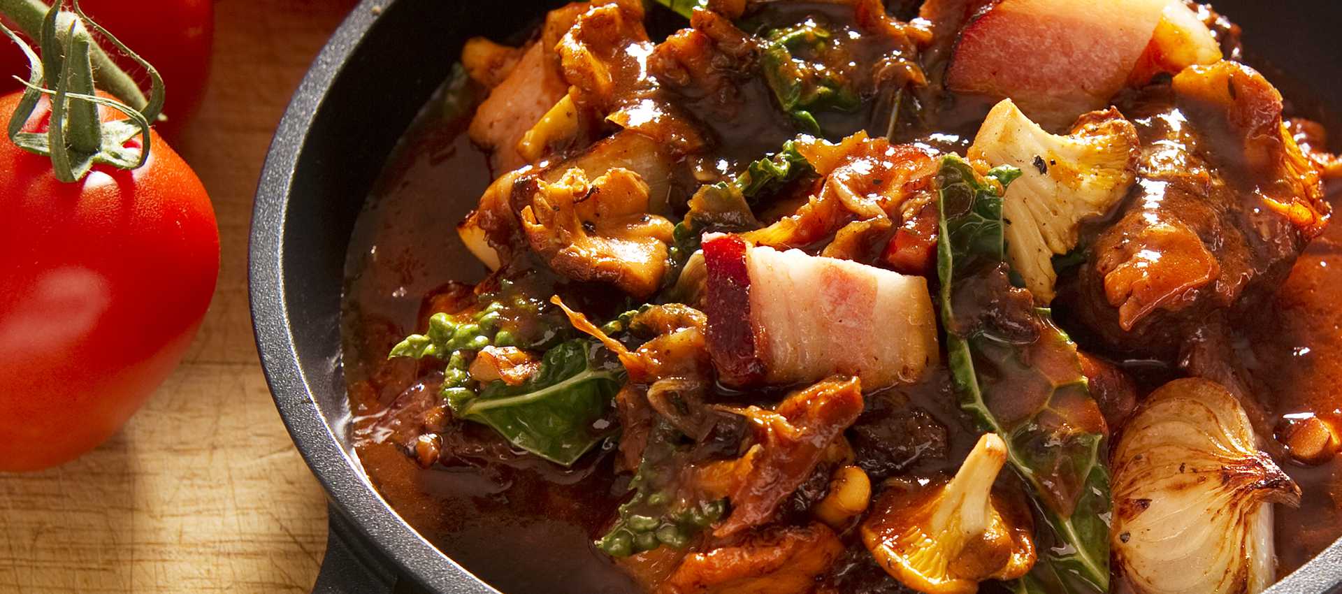 Autumn casserole with bacon, black kale and chanterelles